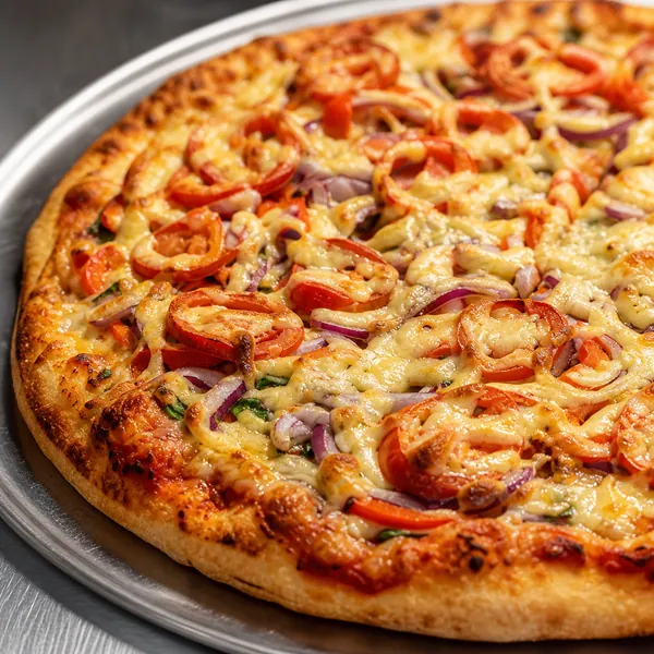 A veggie pizza with tomato, red pepper, and red onion.